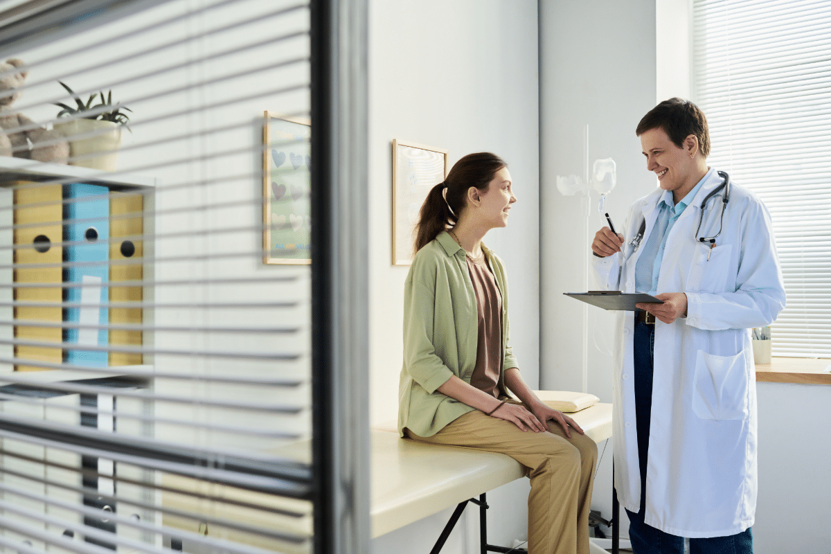 A female patient talking with her healthcare provider on her regular preventative visit.