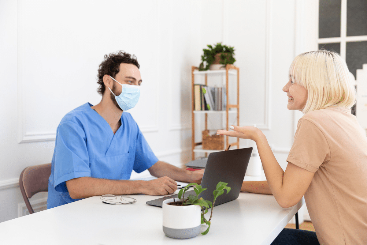 A female patient talking to a healthcare professional during her regular checkup.